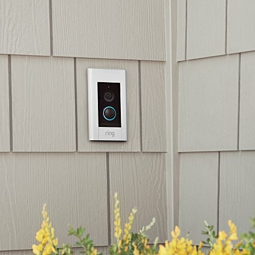Smart doorbell installed on the exterior wall of a house with siding.