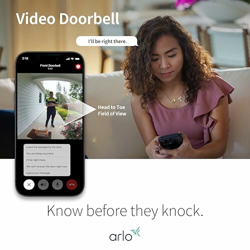 Woman checking video doorbell app on smartphone.