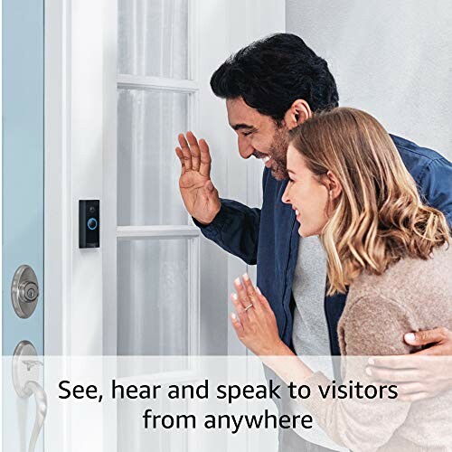 Couple using a video doorbell to greet a visitor.